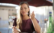 Ragazza con il metabolismo veloce che mangia soddisfatta