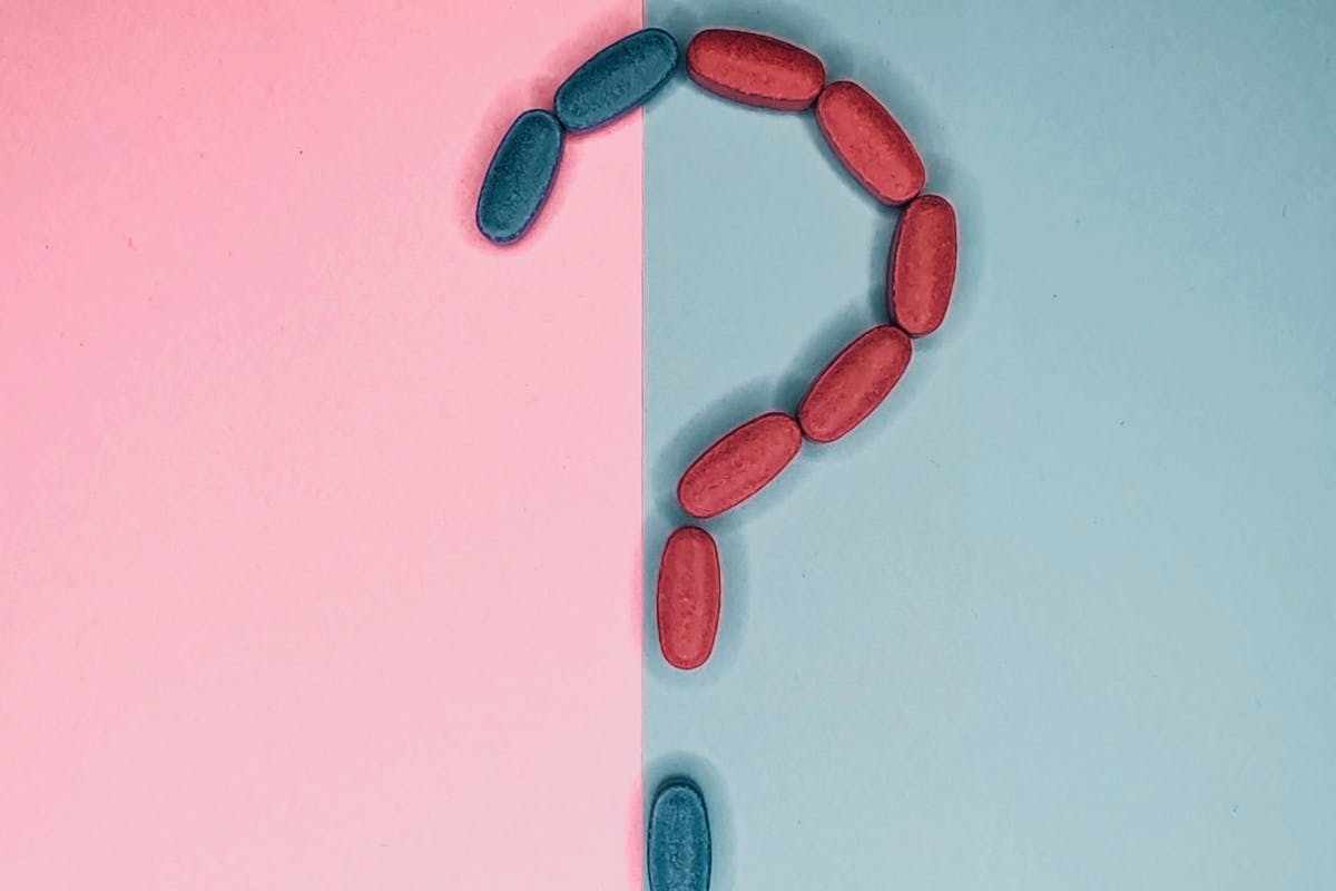 Punto interrogativo con sfondo rosa e azzurro